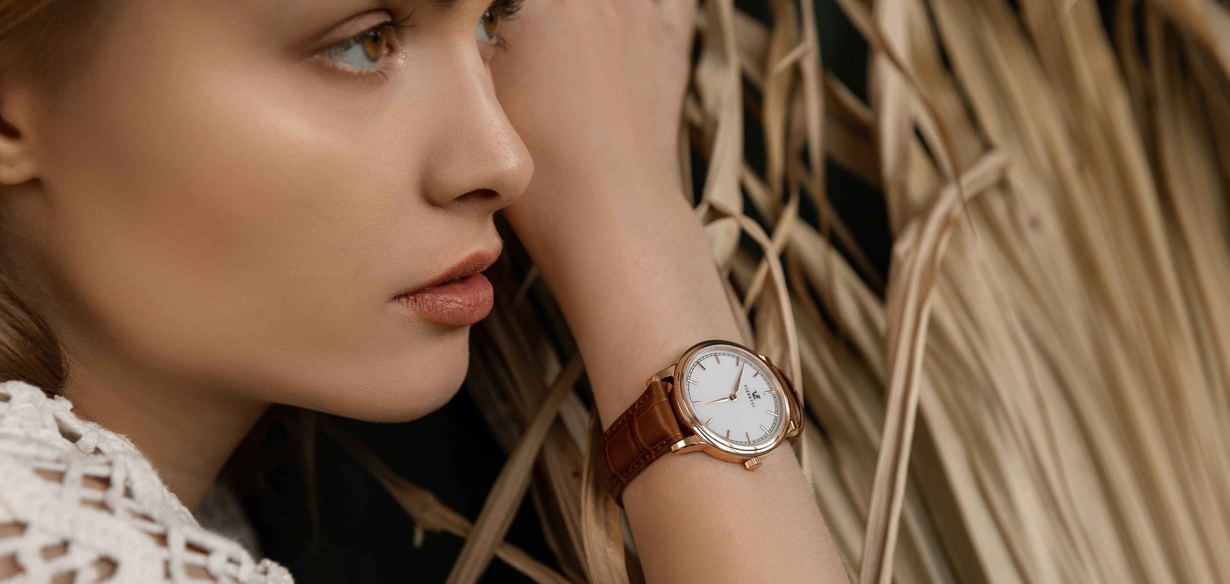 A model for Vizzetti showcasing a Vizzetti watch on her wrist.