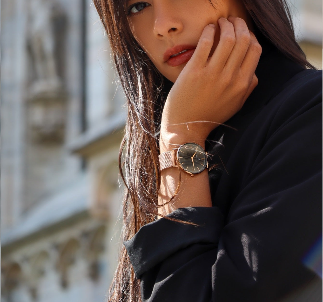 A female model strikes a pose in Italy, showcasing her Vizzetti watch on her hand.